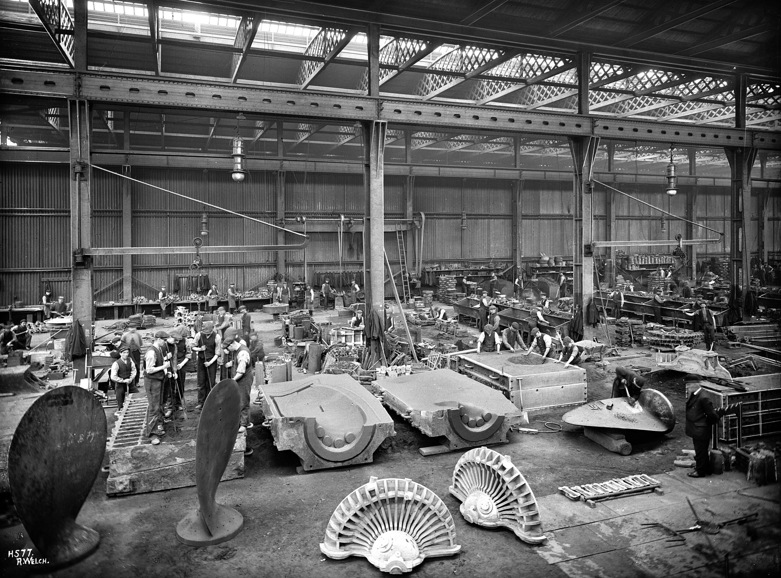 The workshop at Harland & Wolff where castings were made. Here, you can see forms for some of the propeller blades, including a workman finishing a blade on the right from the Titanic Connections Archive